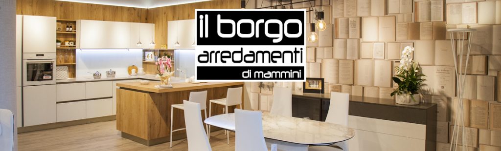 Banner sponsor Il Borgo Arredamenti, interno con cucina moderna e tavolo.