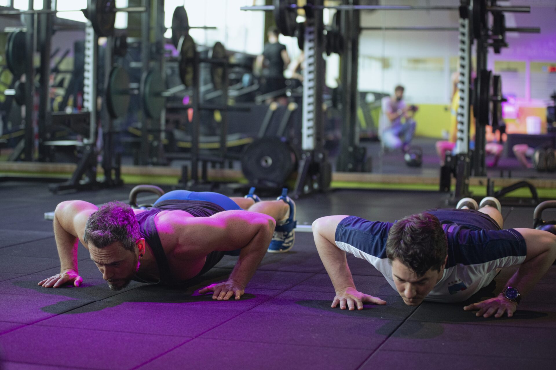 Two men perform push-ups during functional training in the gym at Ego Wellness